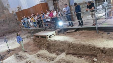 El director de las excavaciones de San Nicolás, Juanjo Bienes -a la izda.-, explica las claves de los trabajos durante una de las visitas.