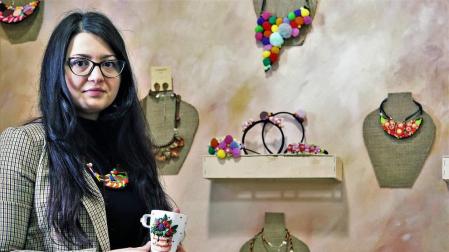Ilona Chirita sujeta una jarra decorada con pasta polimérica, delante de otras de sus creaciones.