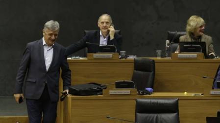 Martínez (Geroa Bai) baja las escaleras del hemiciclo entre Araiz (Bildu) y la presidenta Barkos.