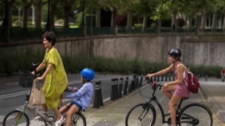 Varias personas cruzan un paso de peatones en bici en Pamplona.