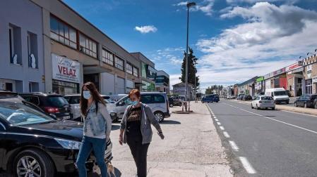 Dos personas caminan por el polígono de Merkatondoa de Estella con mascarilla.