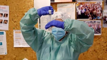 Un sanitario realiza una prueba PCR.