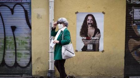 Una mujer pasea con mascarilla por el Casco Antiguo de Pamplona en Jueves Santo.