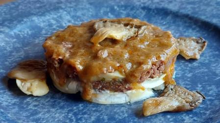 Imagen del plato de ternera en salsa con queso de cabra y setas.