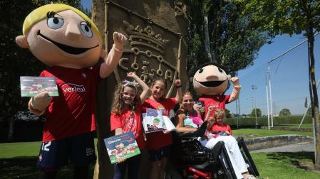 Ana Artázcoz, en el centro, junto a niños de la fundación y las mascotas de Osasuna.
