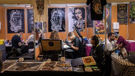 Repartidos en cubículos, varios tatuadores invitados trabajan en Baluarte en la feria del año 2019