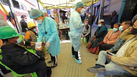 Una funcionaria de Salud de Bolivia hace una encuesta a una persona antes de la vacuna contra la Covid-19
