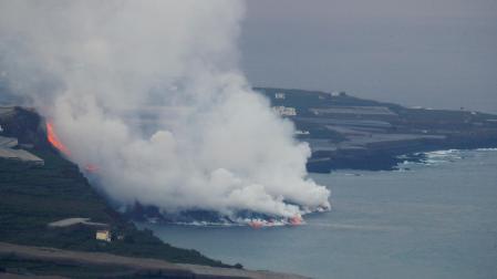 Nube de vapor y gases provocada por la lava del volcán de La Palma al entrar en contacto con el mar