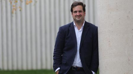 Javier Lipúzcoa Serón posa en la entrada del Edificio Amigos de la Universidad de Navarra