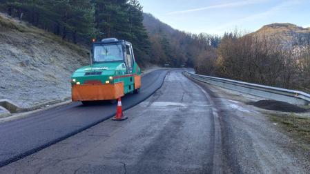 Una apisonadora sobre el firme renovado en la carretera entre Urtasun y Artesiaga