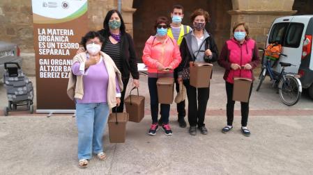 Un grupo de vecinos con el contenedor marrón para depositar la materia orgánica