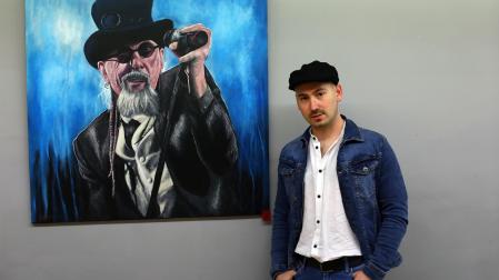 Julen Zubieta, ante la caricatura de El Drogas, en la exposición "El arte del retrato".