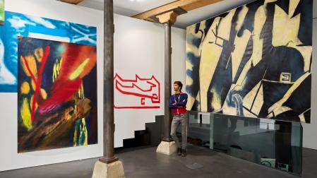 Taxio Ardanaz, junto a parte de las obras de la exposición en Apaindu. A sus espaldas, el  mural de gran formato que ha creado expresamente para el espacio expositivo.