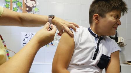 Una enfermera aplica la vacuna contra el papiloma humano a un niño en Galicia
