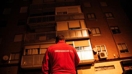 Un trabajador del 112 frente a la vivienda donde una mujer ha envenenado mortalmente a su marido y posteriormente se ha quitado la vida