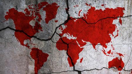 Silueta del mundo con los continentes teñidos de rojo.