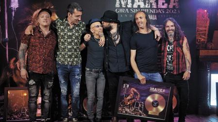 El letrista y cantante de Marea, Kutxi Romero, besa a Fito Cabrales, que entregó al grupo el disco de oro por Los potros del tiempo. Desde la izquierda, Alain Ayerdi (batería), David Díaz Kolibrí (guitarra), Cabrales, Romero, César Ramallo (guitarra) y Edu Beaumont Piñas (bajo)