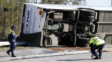 Agentes de la policía inspeccionan el lugar donde se accidentó el autobús
