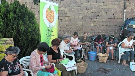 Vecinos y residentes desgranan pochas en la residencia de Sangüesa.