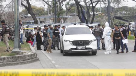 Policías investigan el vehículo con impactos de bala en el que se encontraba el fiscal César Suárez al ser asesinado