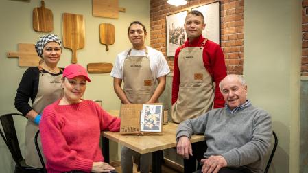 Irina y Raúl, sentados, junto al equipo del restaurante de La Tablita, en la calle Esquíroz
