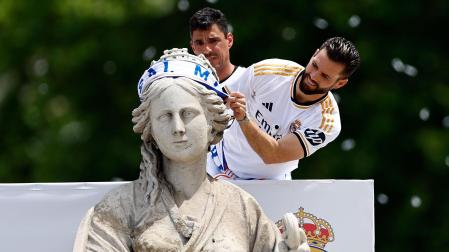 El capitán del Real Madrid, Nacho Fernández, coloca una bufanda a la diosa Cibeles durante la celebración con aficionados de la Liga número 36