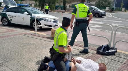 Dos agentes de la Guardia Civil de Tráfico reducen esta mañana de lunes a un hombre que tuvieron que sacar en estado ebrio de una villavesa por increpar a los pasajeros.