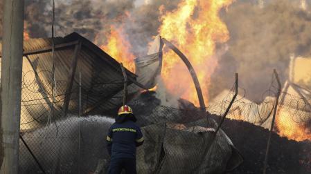 Un bombero lucha contra las llamas que cercan a la capital griega