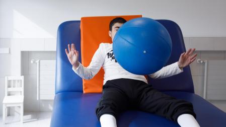 Un niño, haciendo ejercicios de rehabilitación