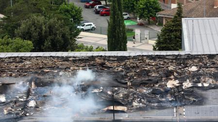 Fotos del incendio en el tejado del edificio de Policía Municipal de Pamplona ya controlado. /