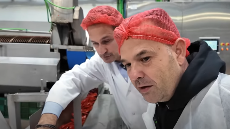 El empresario José Elías, en primer término, atiende las explicaciones de Pedro Luis, detrás, en el proceso de elaboración de la conserva de pimiento del piquillo de Lodosa.