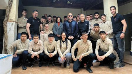 Alumnado y profesores de Salesianos posan con vecinos de Paiporta en una de las viviendas