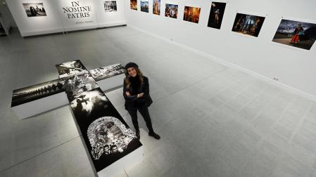 Ainhoa Tejerina posa en la exposición junto a una cruz creada con varias de sus fotografías /