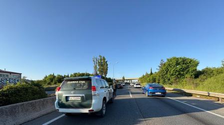 Imagen de un coche de la Guardia Civil, entre las retenciones ocasionadas por al accidente en la Ronda