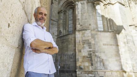 El doctor en Historia del Arte José Luis García Lloret posa ante la parte románica del ábside de la Seo del Salvador de Zaragoza /
