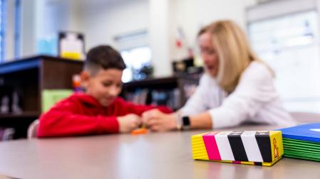 Una especialista de apoyo educativo con un menor con necesidades especiales
