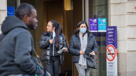 Dos mujeres salencon mascarillas quirúrgicas del interior de un centro sanitario