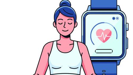 Una mujer medita con un pulsómetro registrando la actividad a su lado
