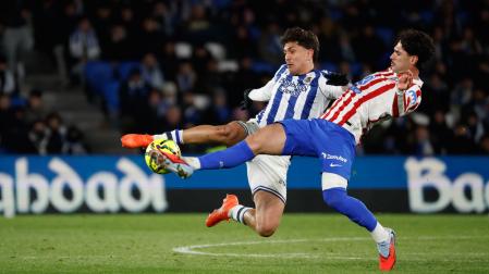 El centrocampista del Atlético de Madrid Jonny Cardoso (d) lucha con Jon Aramburu, de la Real Sociedad, durante el partido