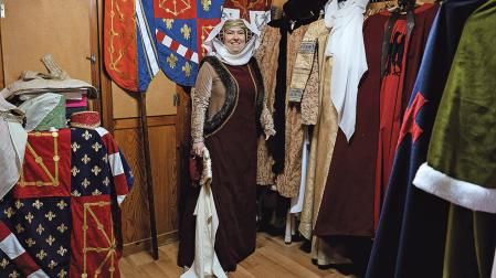 Estrella Iriarte, ataviada con un traje confeccionado por ella, junto a los que guarda en su taller