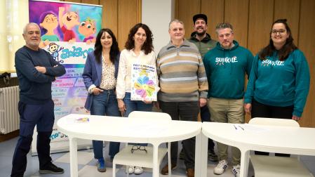 Luis Vila (Berriozar), Izaskun Larumbe Y Cristina Delgado (ADANO), David Artuch (Tenampas), Jokin Ventosa (junta de ADANO), Iván Martín y Leyre Meléndez (Batukada Sunkile), durante la presentación de la III Fiesta Solidaria de ADANO