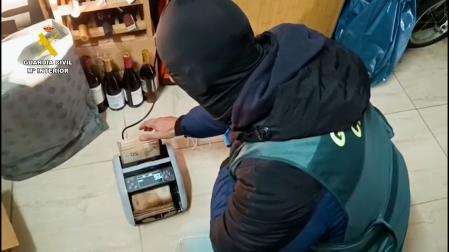 Un agente de la Guardia Civil con una máquina de dinero