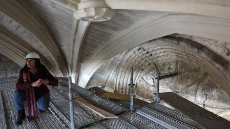 La arquitecta de Príncipe de Viana Amaia Prat Aizpuru, bajo la bóveda del atrio sobre la que se ha intervenido. Tras ella, el tímpano de la portada, muy deformado