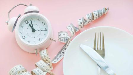 Time to lose weight , eating control or time to diet concept , alarm clock with healthy tool concept decoration on blue background