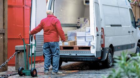 Un trabajador de reparto descarga su furgoneta
