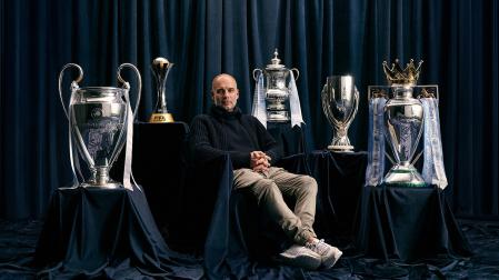 Pep Guardiola posa junto a los títulos conseguidos con el Manchester City