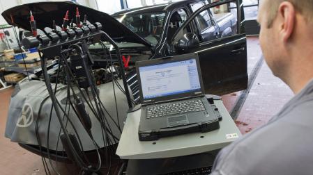 Un mecánico carga una actualización de software en un coche.