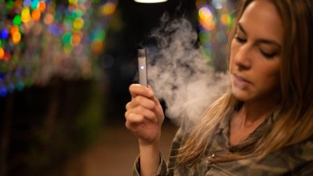 Una joven, vapeando