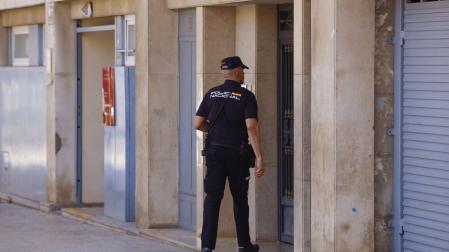 Un agente accede al edifico donde la Policía Nacional ha hallado el cadáver de un varón en una nevera en un piso en la ciudad de Castellón