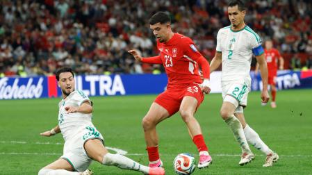 Ramy Bensebaini y Aissa Mandi pelean un balón ante Zeki Amdouni durante el partido Suiza y Argelia
